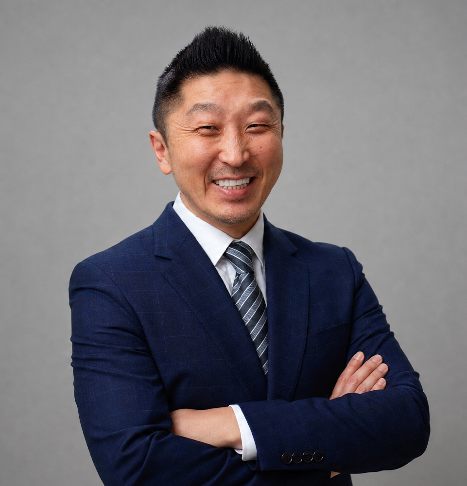 Meet Dr. Charles Lee. Here he is smiling in his suite in a grey background